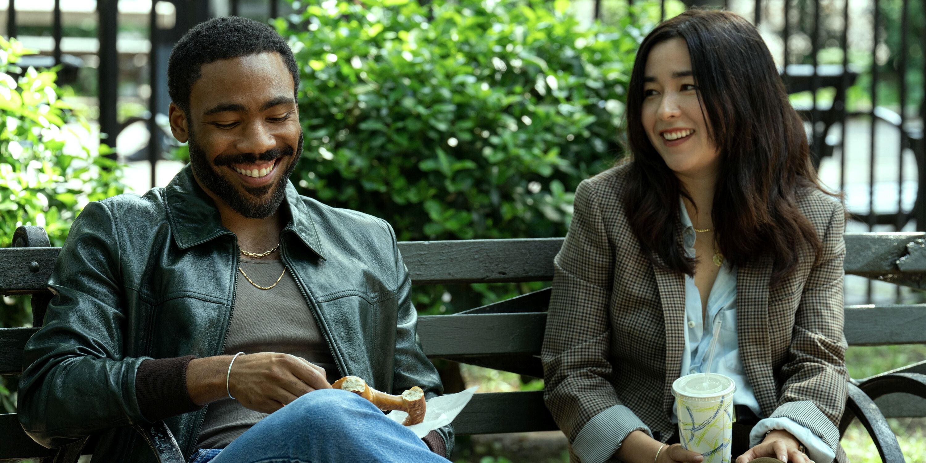 Donald Glover as John Smith and Maya Erskine as Jane Smith sitting on a park bench in Mr.  & Mrs.  Smith