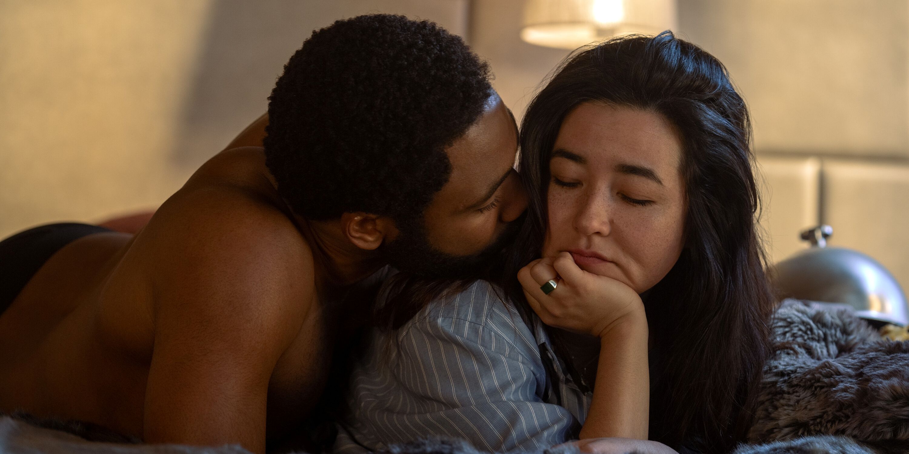 Donald Glover as John Smith and Maya Erskine as Jane Smith laying in bed in Mr. &amp; Mrs. Smith