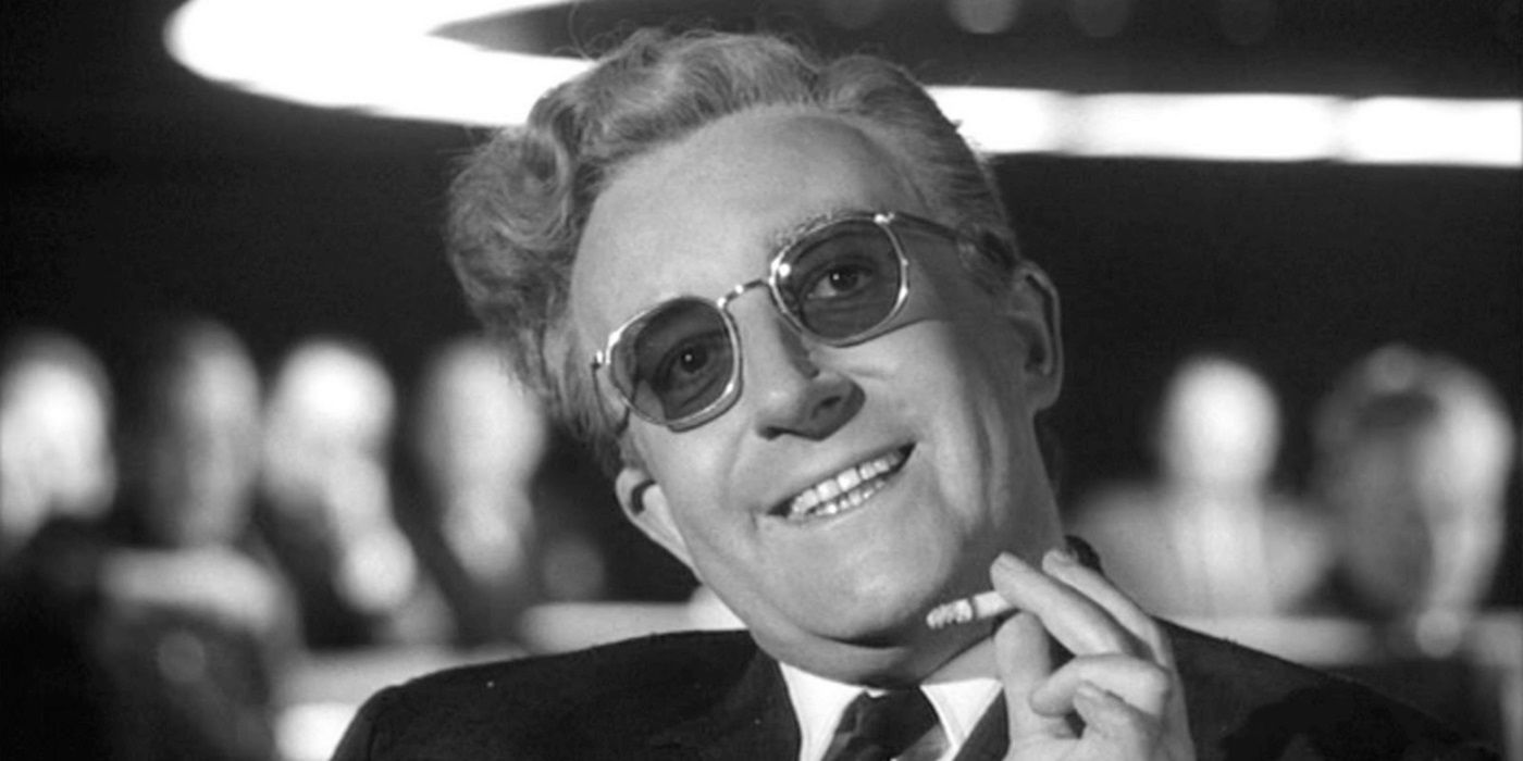 Peter Sellers as Dr. Strangelove smoking a cigarette and smiling in Stanley Kubrick's Dr. Strangelove 