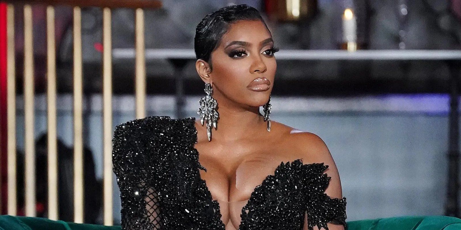 Porsha Williams sits in Black gown looking indignant at RHOA S13 reunion