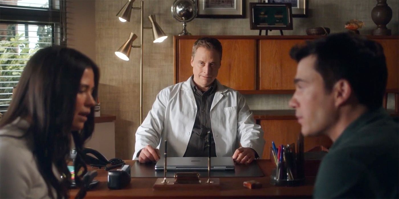 Alan Tudyk as Harry watching a couple speaking in Resident Alien