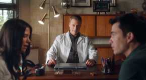 Alan Tudyk as Harry watching a couple speaking in Resident Alien