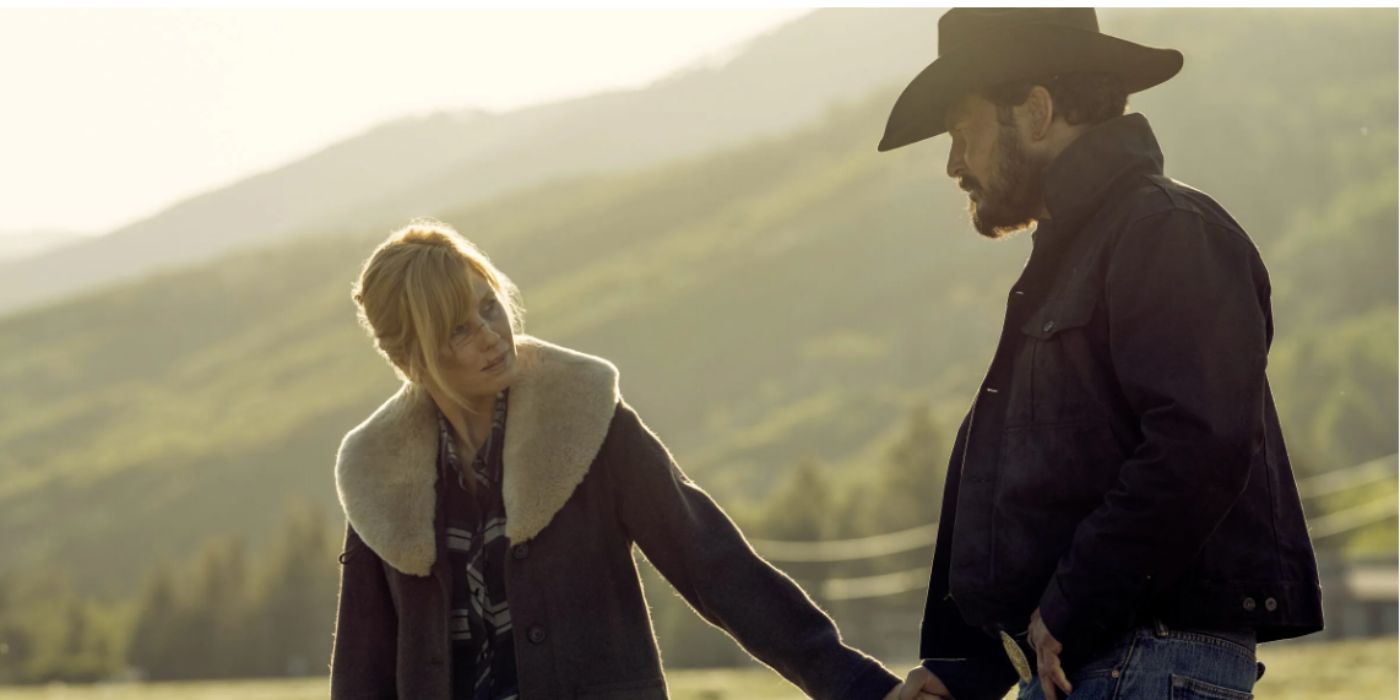 Kelly Reilly and Cole Hauser as Beth Dutton and Rip Wheeler holding hands outside in coats in 'Yellowstone'