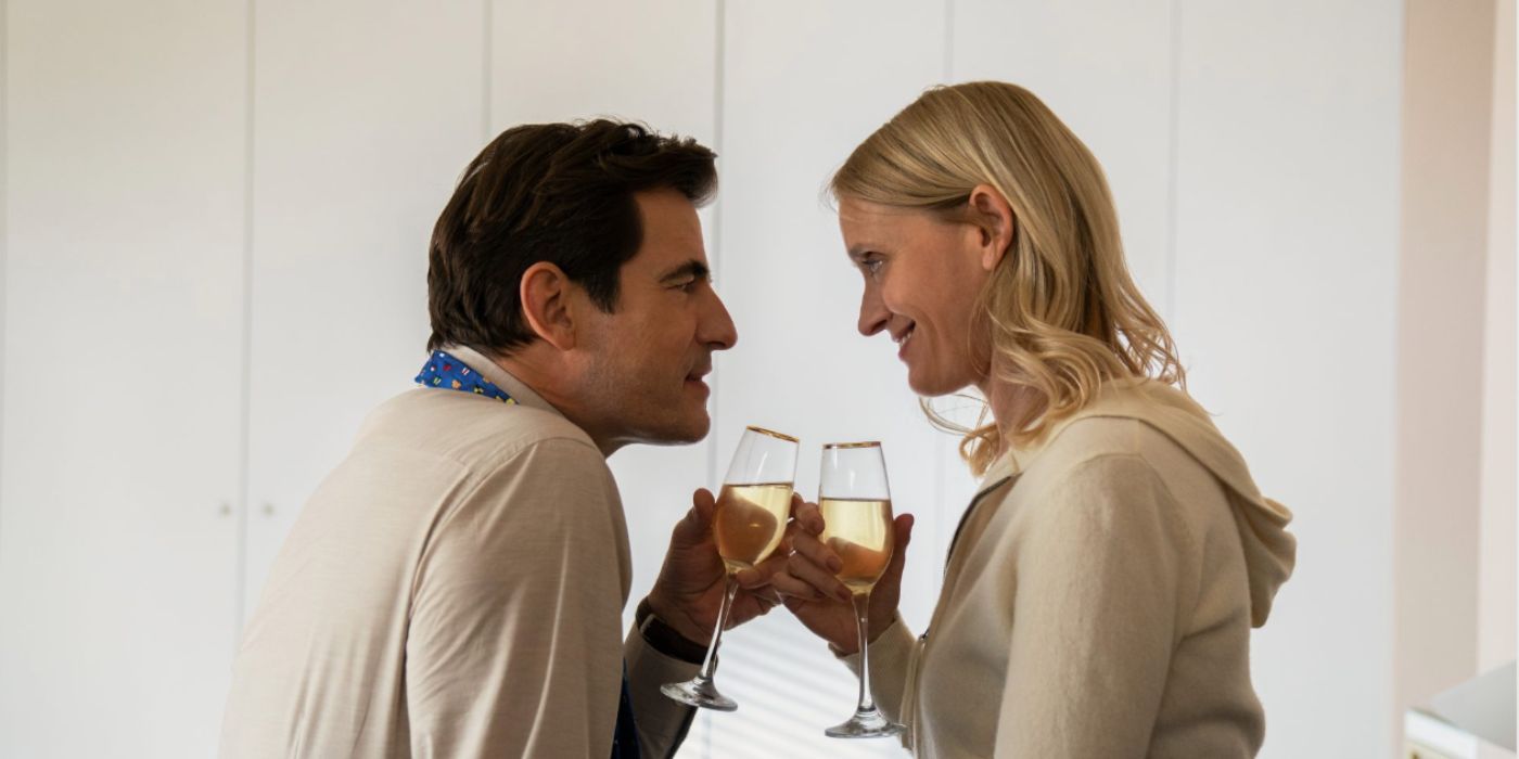 Claes Bang and Anne-Marie Duff as John Paul and Grace Williams holding champagne glasses in Bad Sisters.