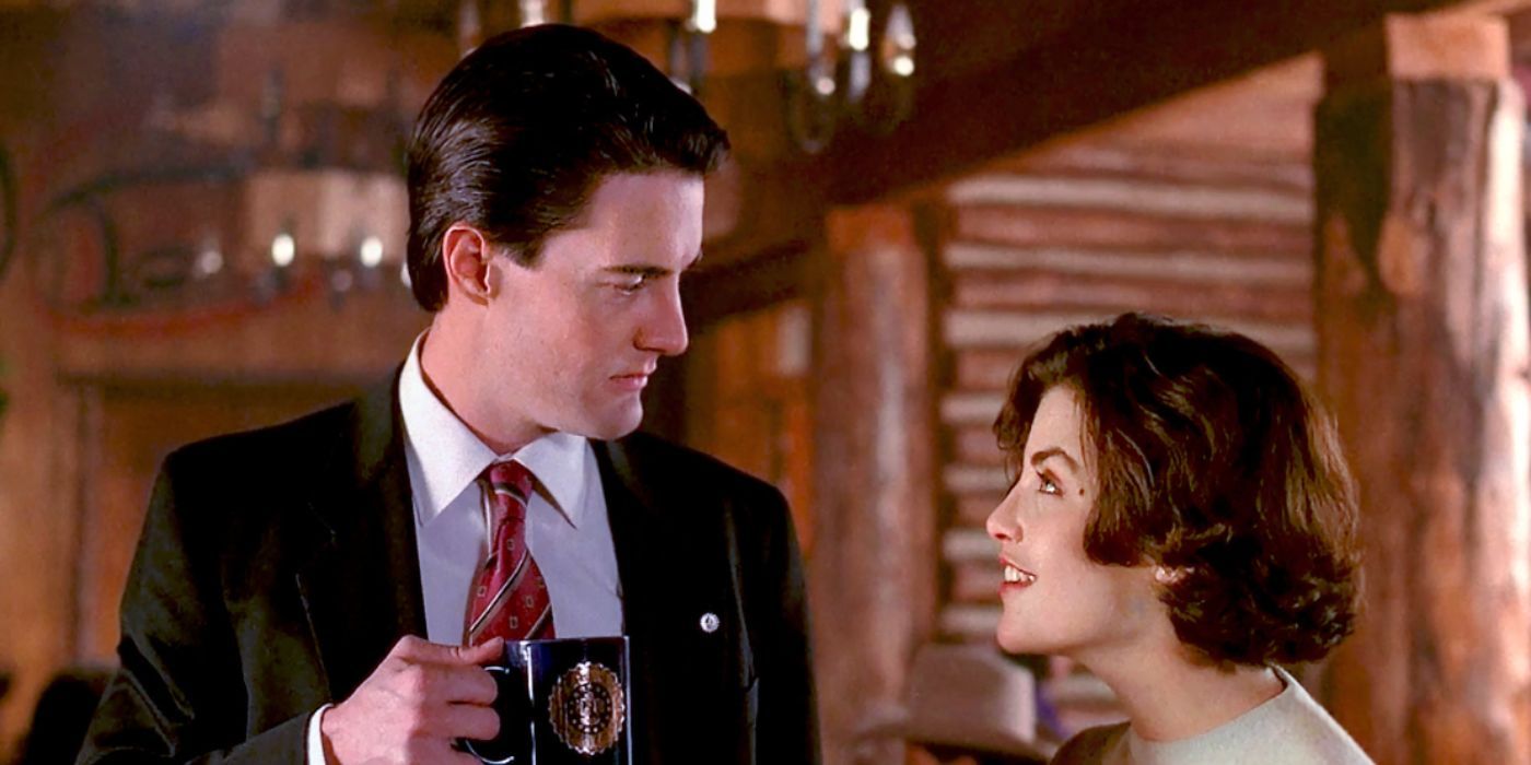 Kyle Maclachlan and Sherilyn Fenn as Dale Cooper and Audrey Horne holding a coffee cup in 'Twin Peaks'