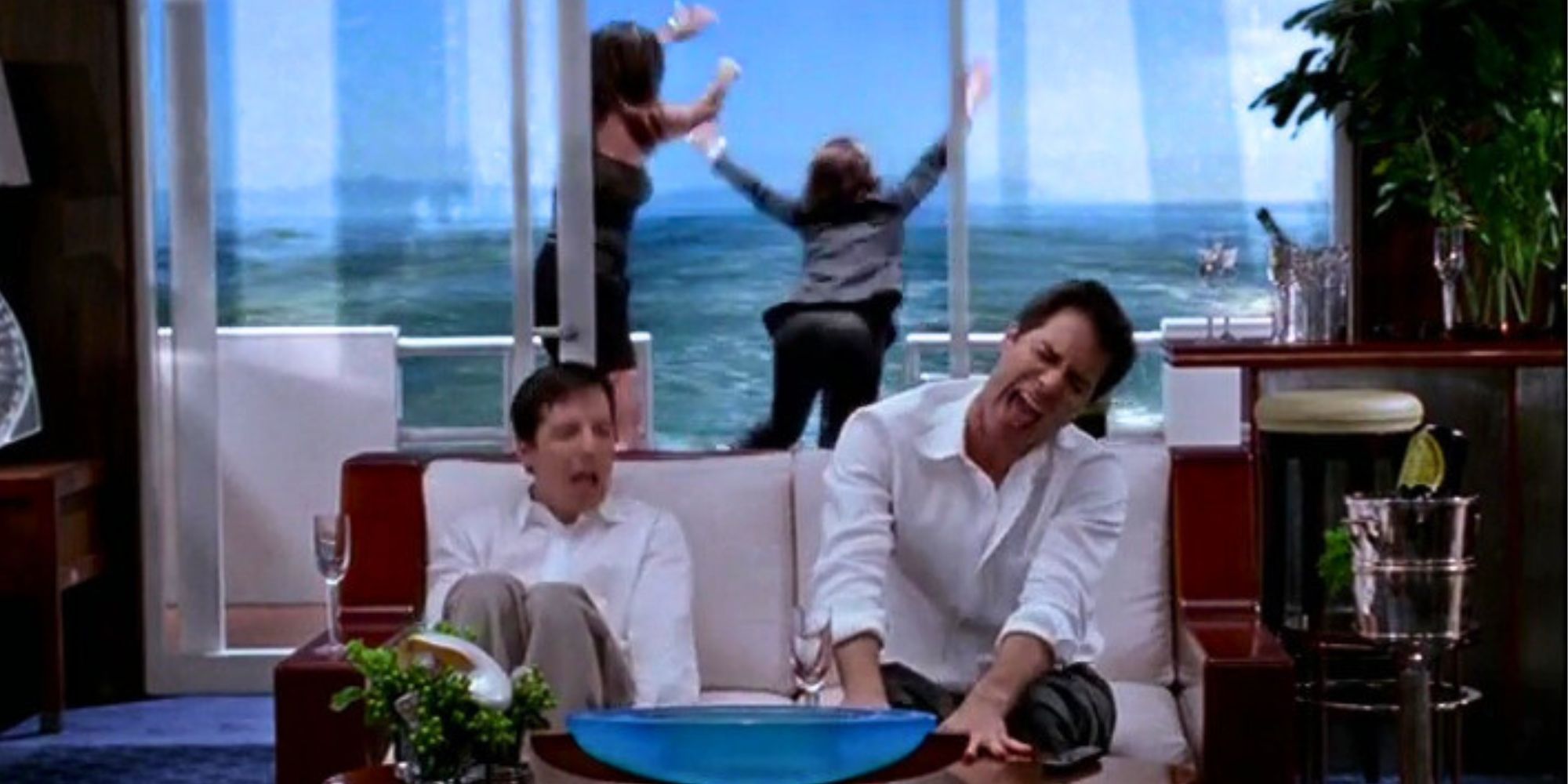 Sean Hayes and Eric McCormack singing on a boat while Minnie Driver pushes Megan Mullally overboard in Will &amp; Grace