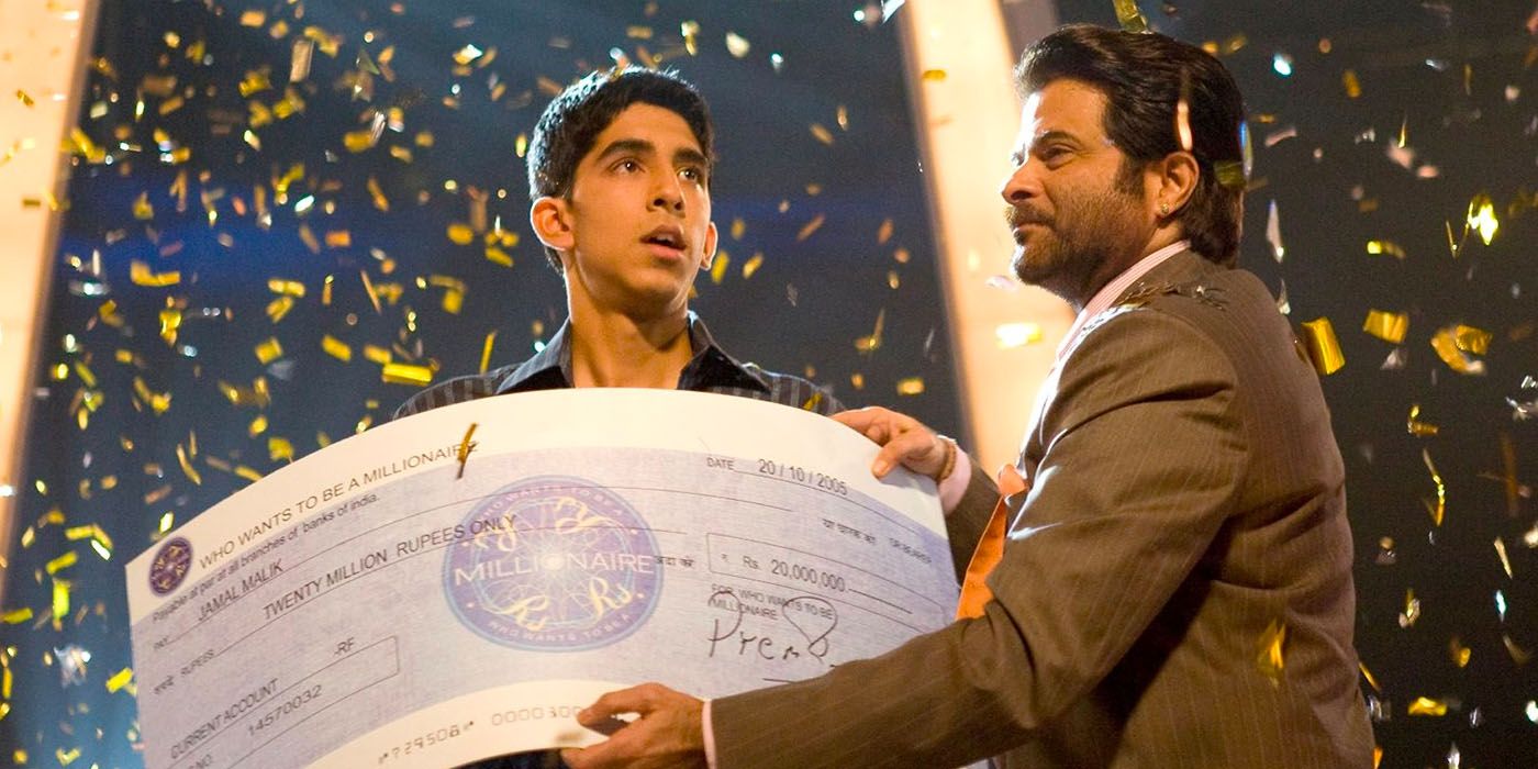 Anil Kapoor hands over a 'Who Wants to Be a Millionaire' check to Dev Patel's character in Slumdog Millionaire