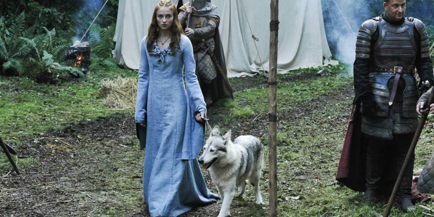 Sansa Stark walking with her direwolf, Lady, in Game of Thrones