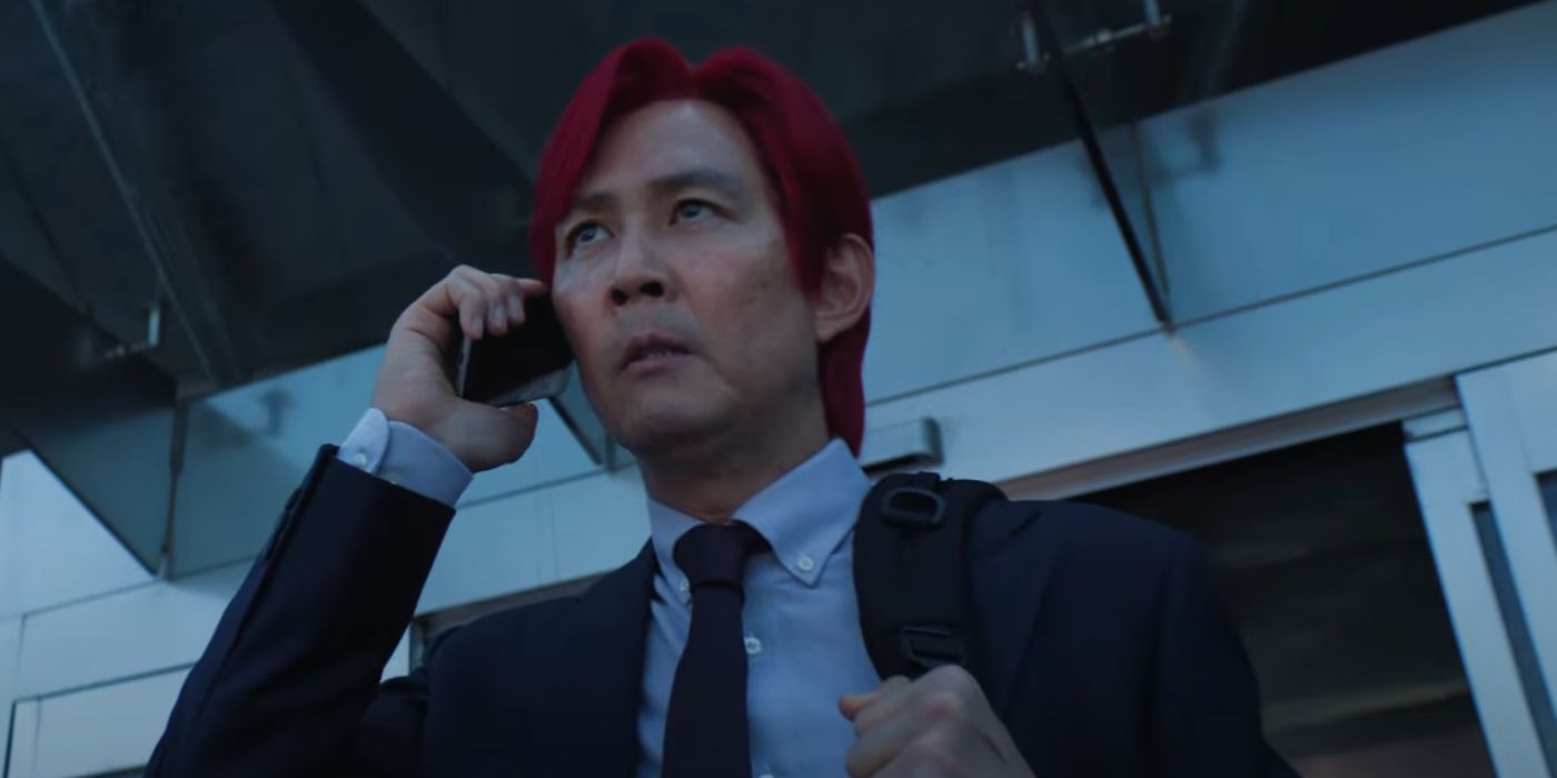 Lee Jung-jae as Gi-hun, with pink hair, talking on the phone, in Squid Game Season 2