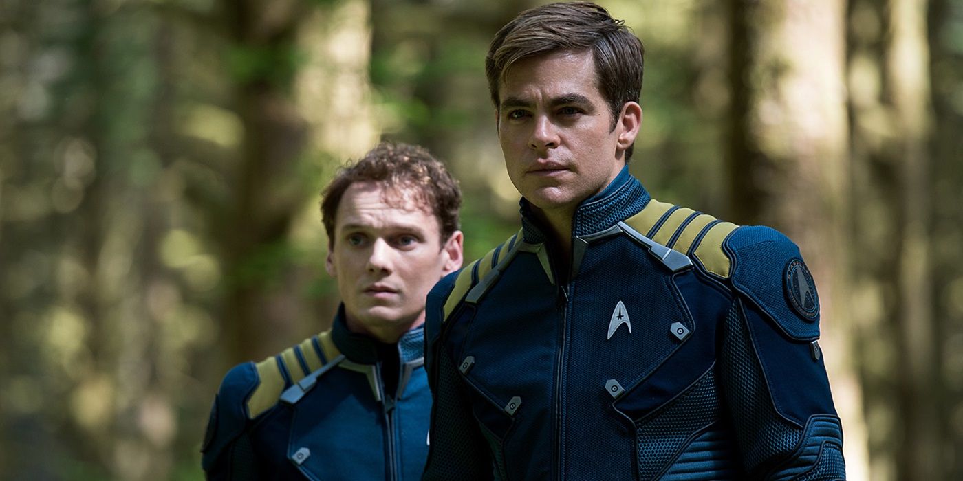 Anton Yelchin as Pavel Chekov and Chris Pine as James T. Kirk standing in the woods in Star Trek Beyond