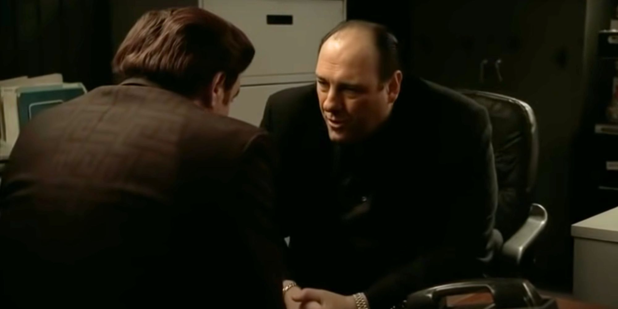 Steven Van Zandt looking at James Gandolfini sitting across from him in The Sopranos