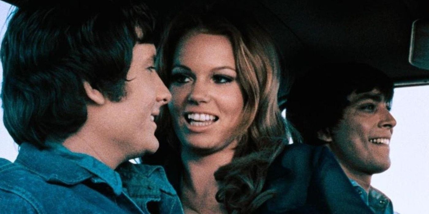 A woman firliting with two men in a car in Supervixens 1975