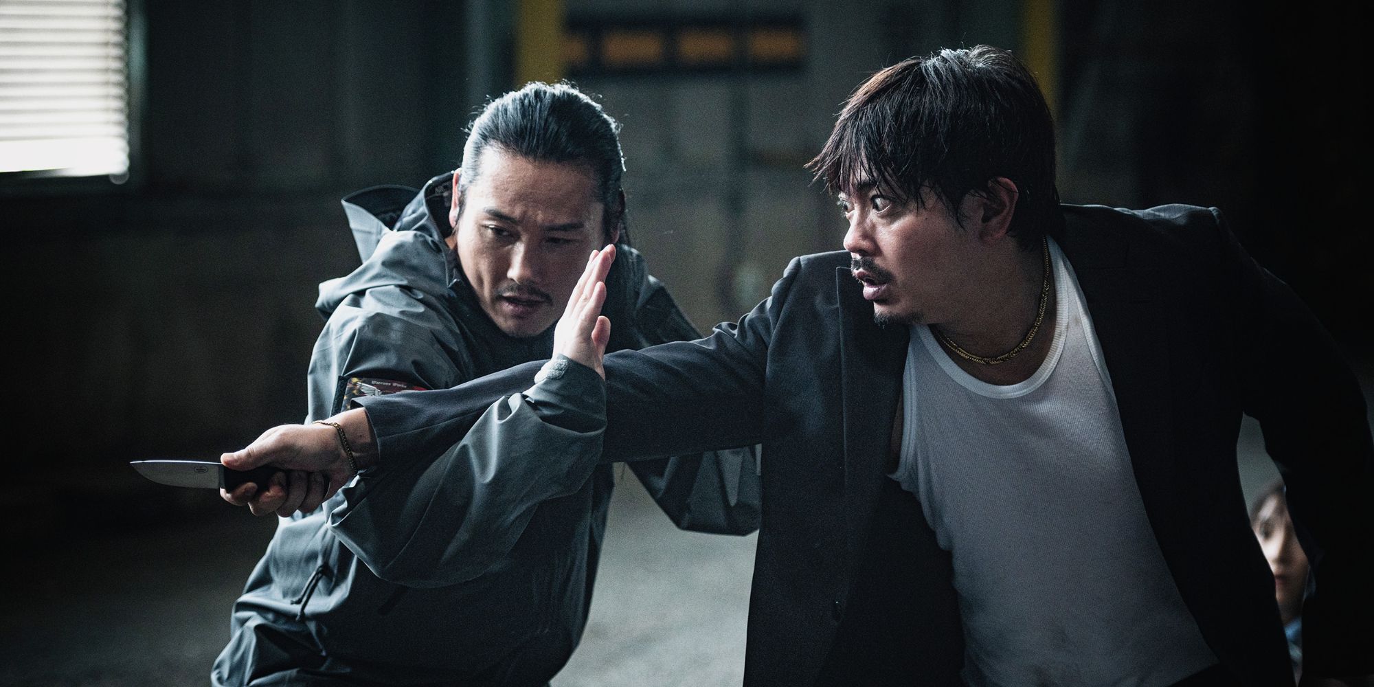Tak Sakaguchi stopping an attacker with a knife in One Percenter (2023)