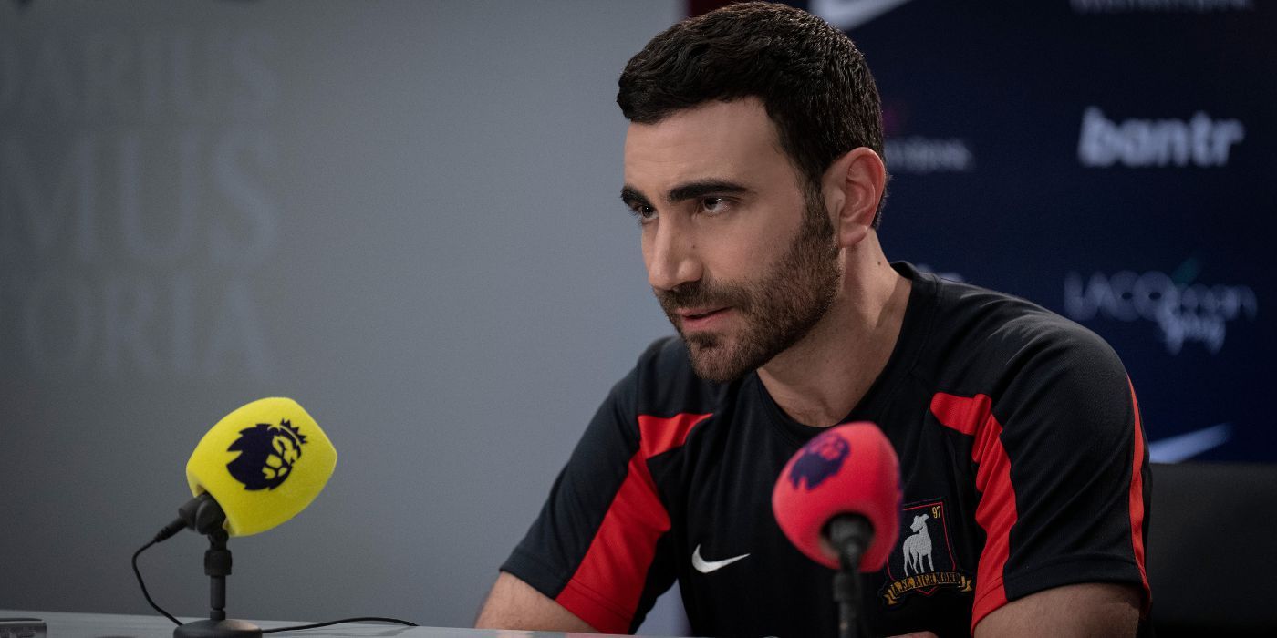 Brett Goldstein as Roy Kent in Ted Lasso Season 3 speaking during a press conference