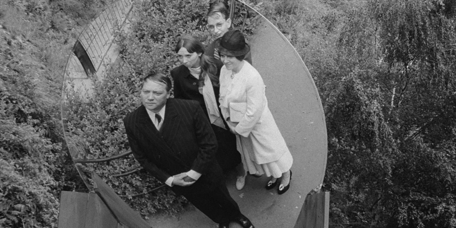 Karel (Rudolf Hrušínský) and his family look at a convex mirror in The Cremator.