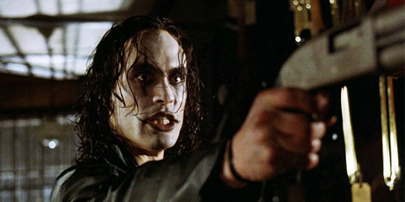 Brandon Lee as Eric pointing a gun at someone in The Crow