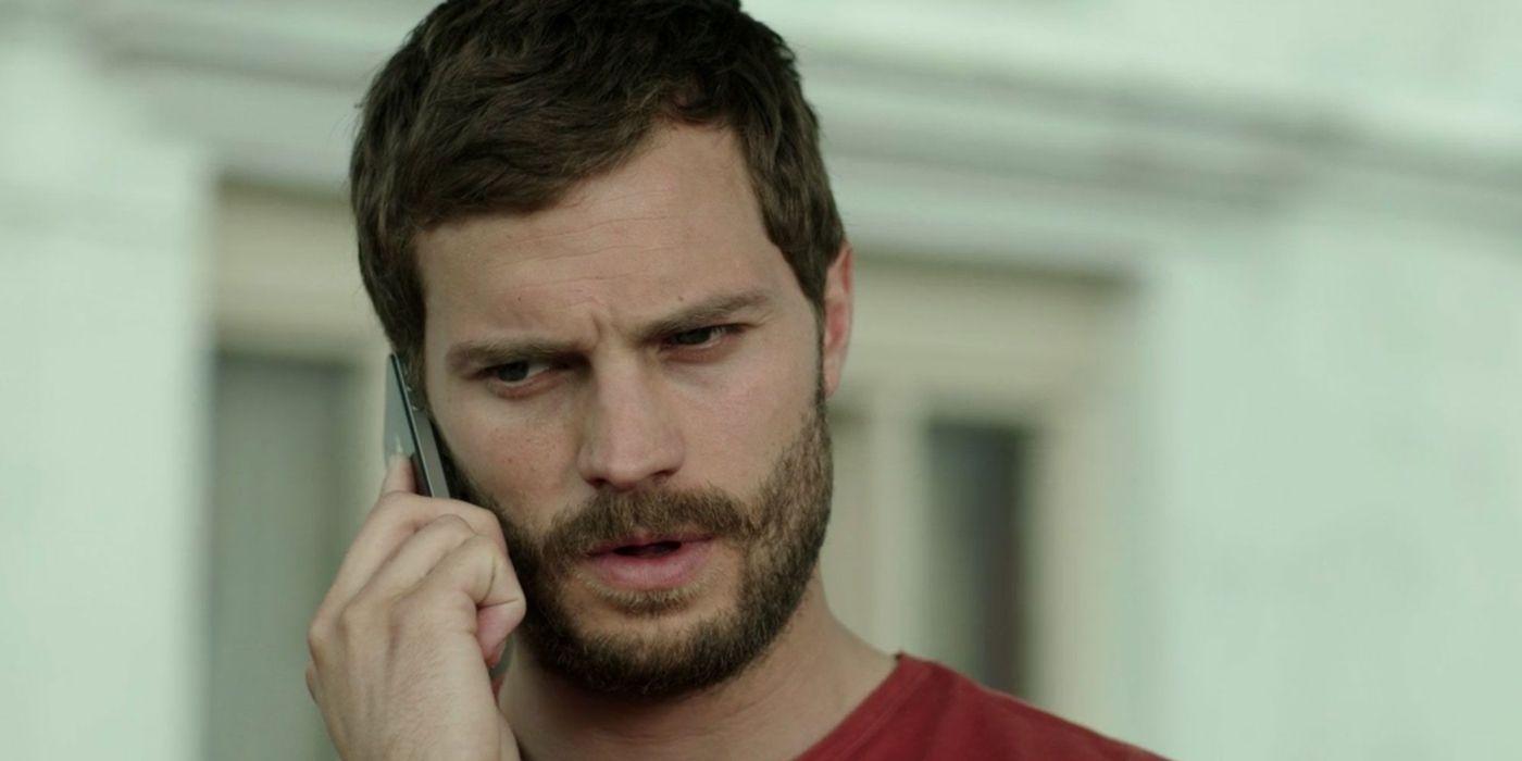 Jamie Dornan as Paul Spector on the phone and looking slightly away to the left in The Fall