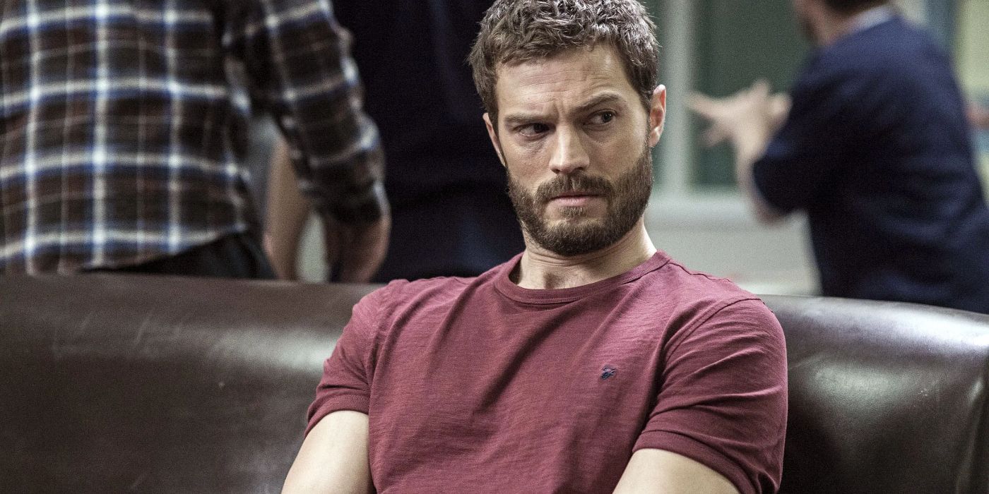 Jamie Dornan as Paul Spector sitting on a leather couch and looking to the right in The Fall