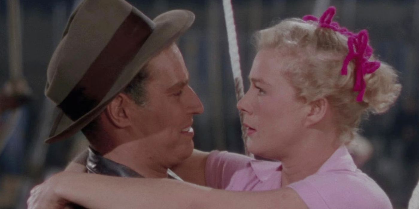 Charlton Heston as Brad Braden and Betty Hutton as Holly, looking at each other and hugging in The Greatest Show on Earth