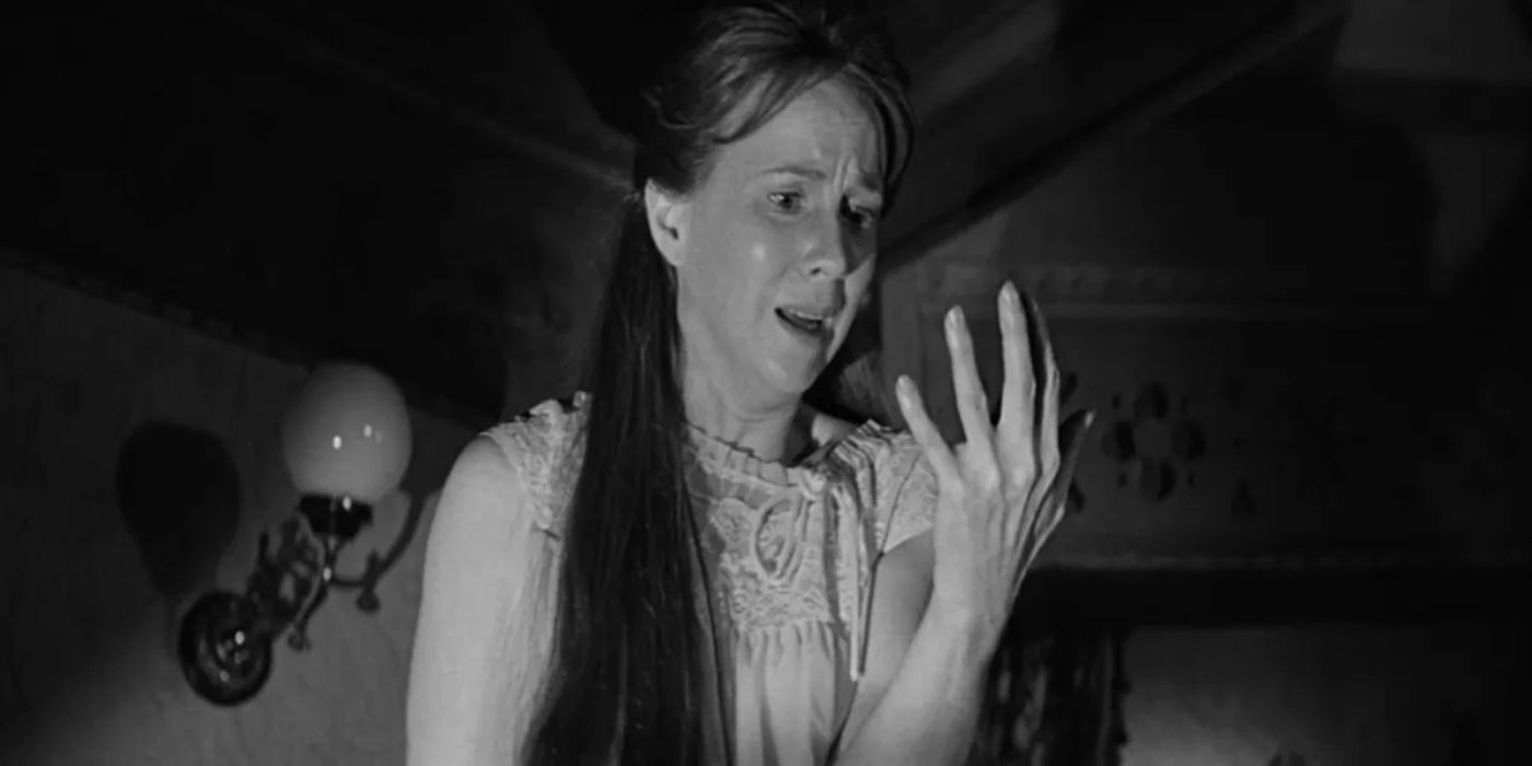 Eleanor Lance, played by Julie Harris, stares at her hand in The Haunting (1963)