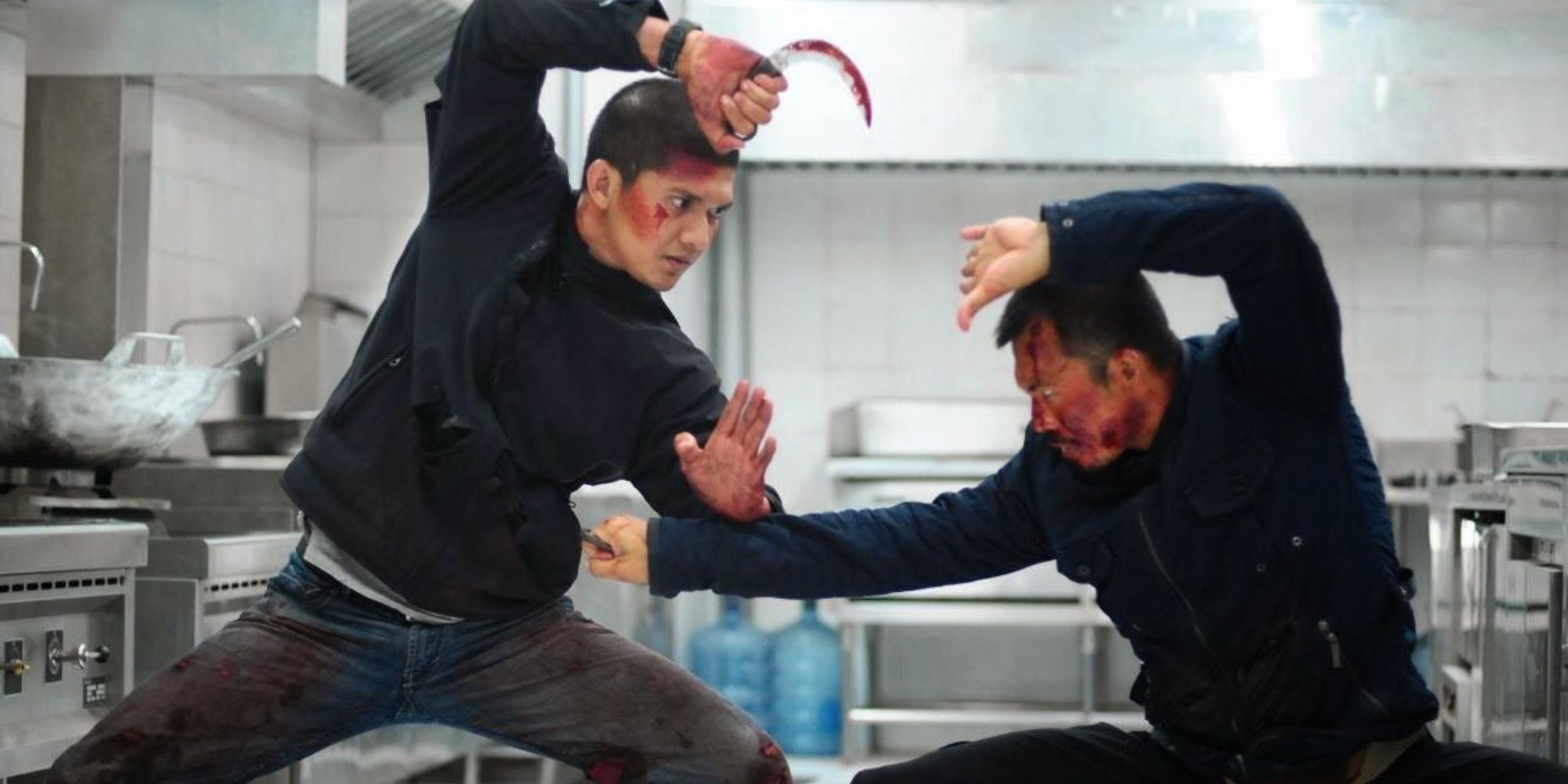 Two men fighting in a kitchen in The Raid 2
