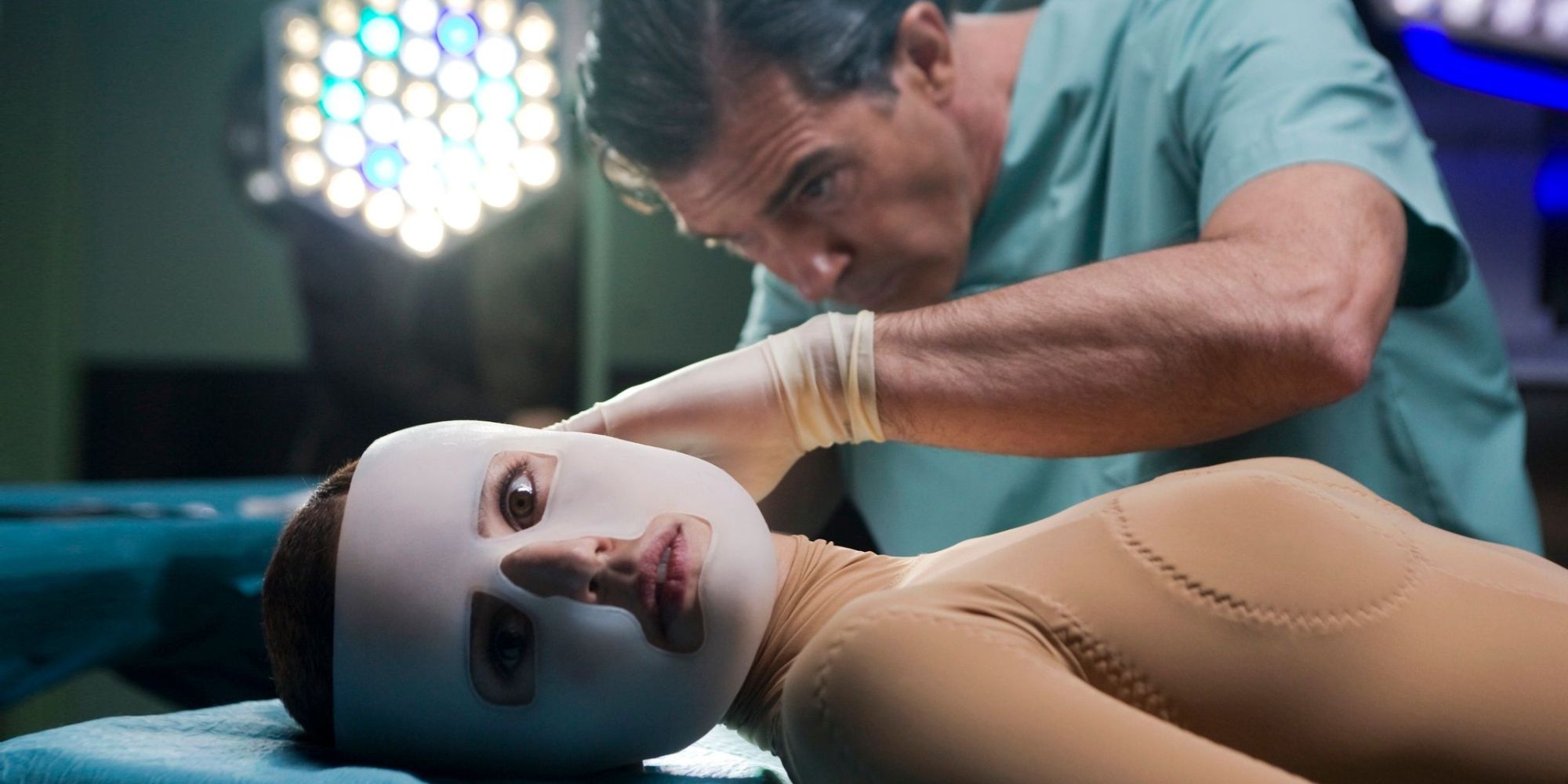 A surgeon working on a woman with her face covered in bandages in The Skin I Live In - 2011