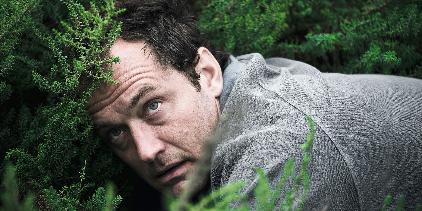 Jude Law hiding in a bush in The Third Day