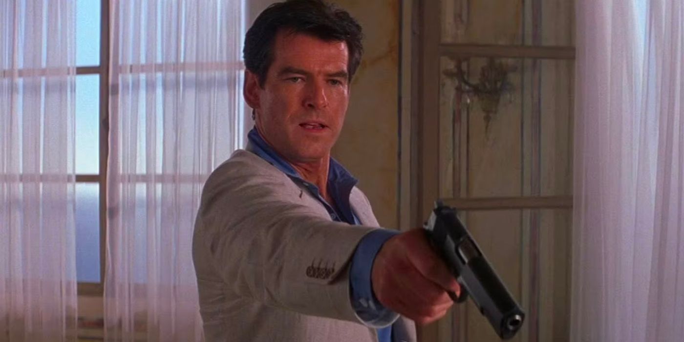 James Bond (Pierce Brosnan) stands in a light suit, aiming a pistol as he stands in the bedroom of a coastal villa.