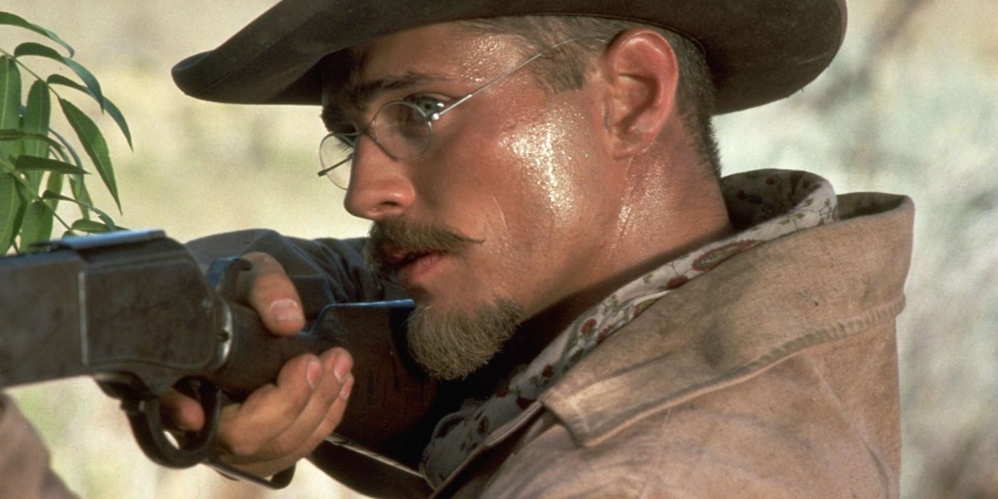 Actor Jason Priestly as Billy Breckenridge, pointing a rifle in Tombstone.