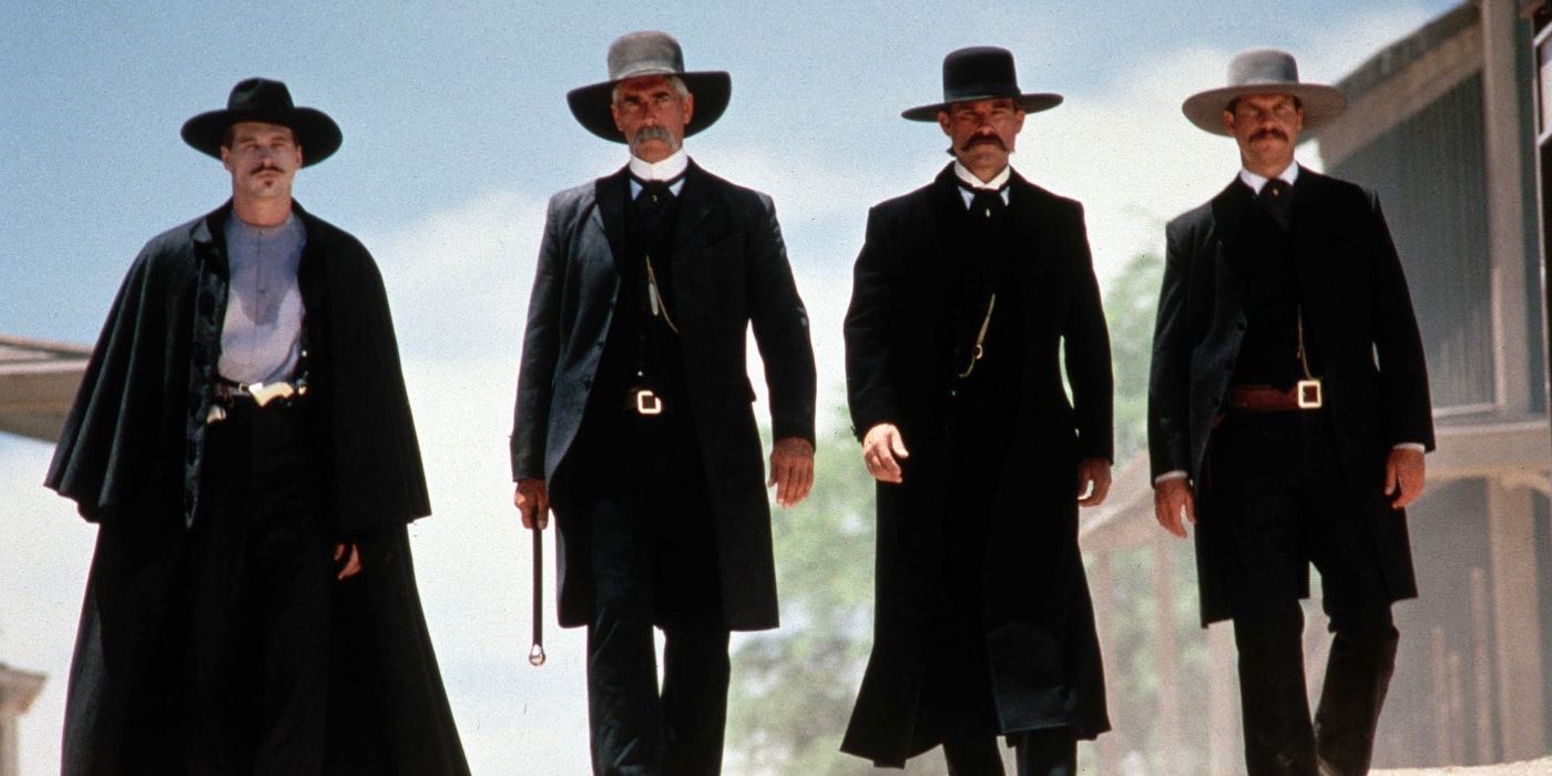 Val Kilmer as Doc Holliday, Sam Elliott as Virgil Earp, Kurt Russell as Wyatt Earp, and Bill Paxton as Morgan Earp walk down the street in Tombstone