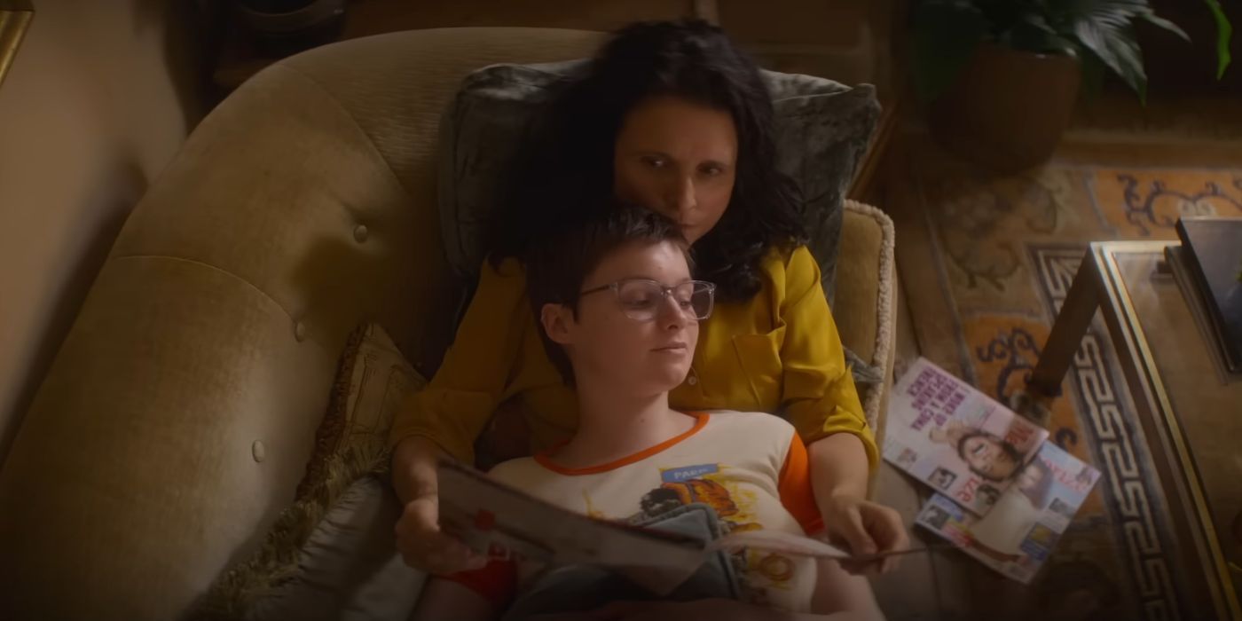 Lola Petticrew as Tuesday, lying on top of Julia Louis-Dreyfus as Zora, reading a magazine on a couch.