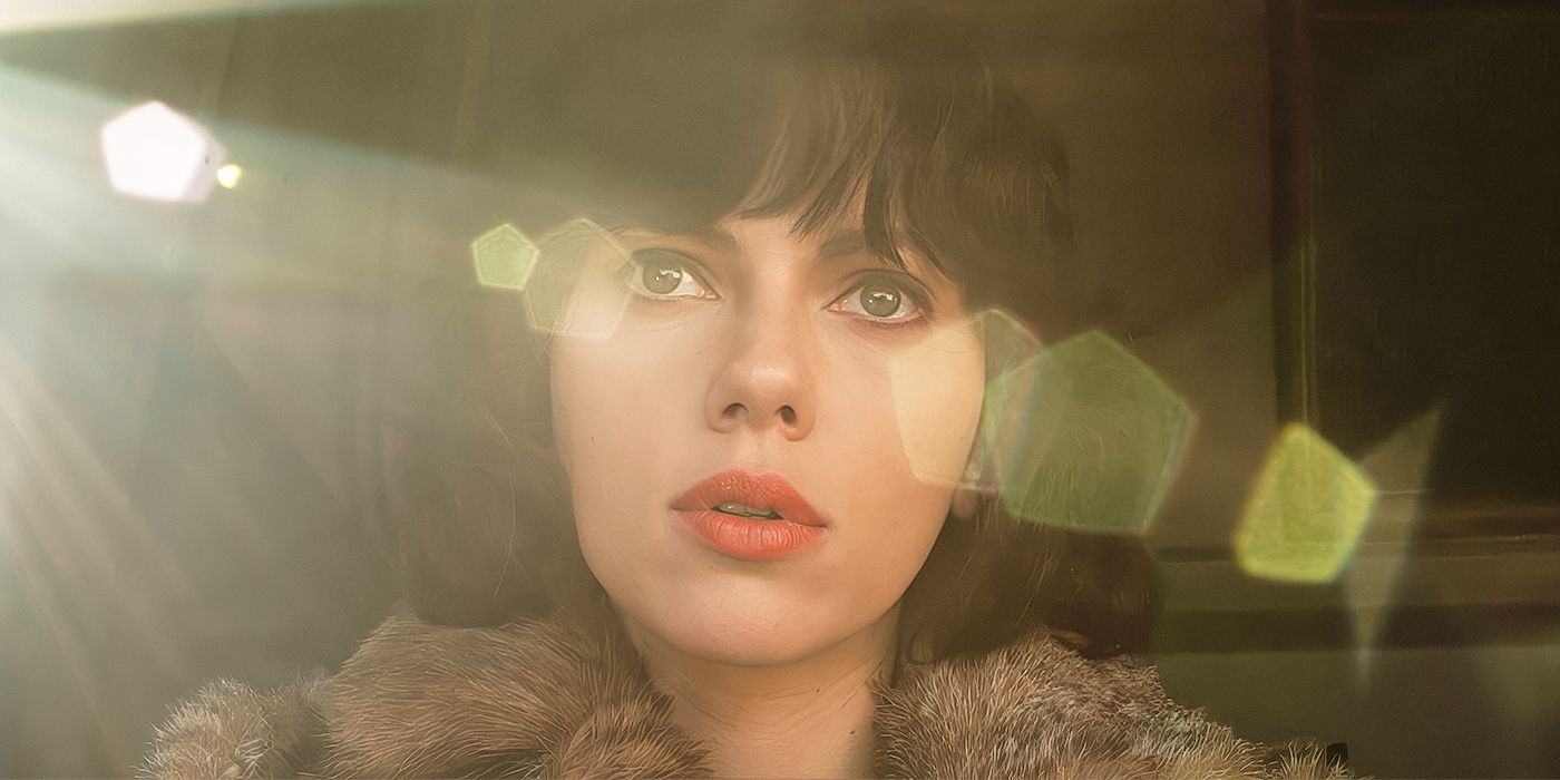 Scarlett Johansson looking at the distance with a sun glare in her face in Under the Skin