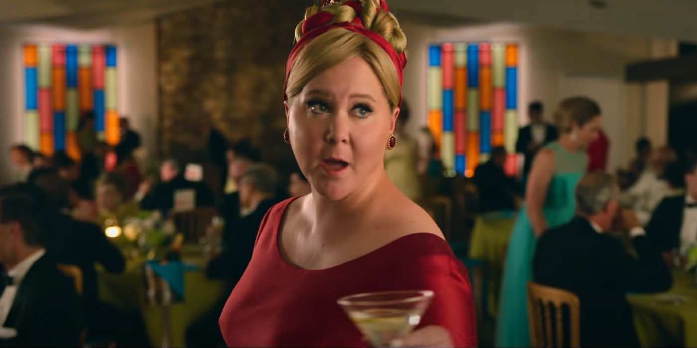 Amy Schumer at a party holding a martini in Unfrosted: The Pop-Tart Story
