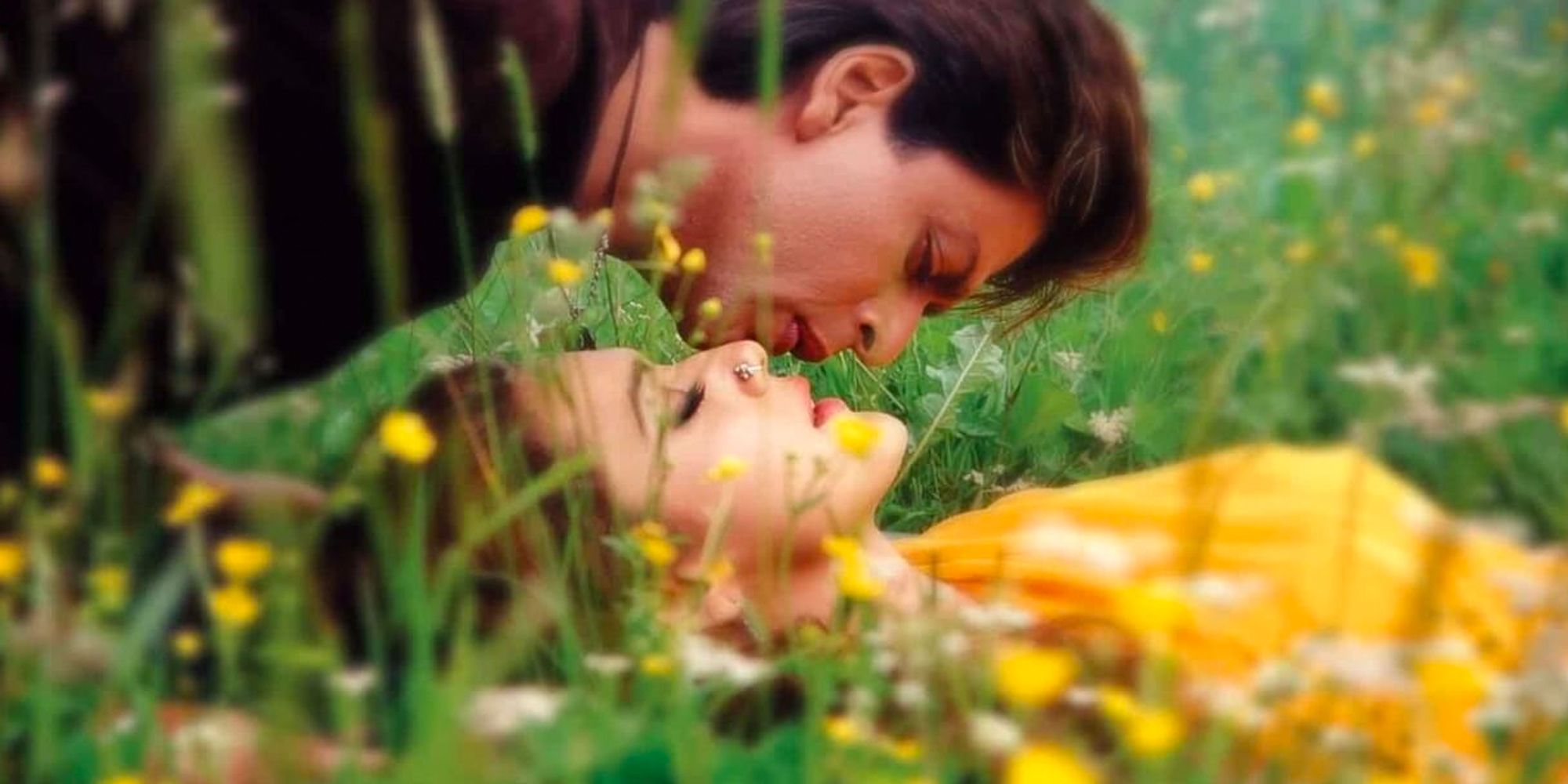 Shah Rukh Khan laying in a field with a girl