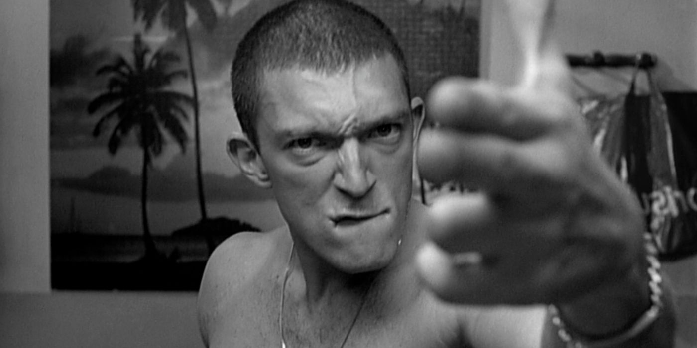 Vinz looking and pointing at the camera while biting his lip in 'La Haine'