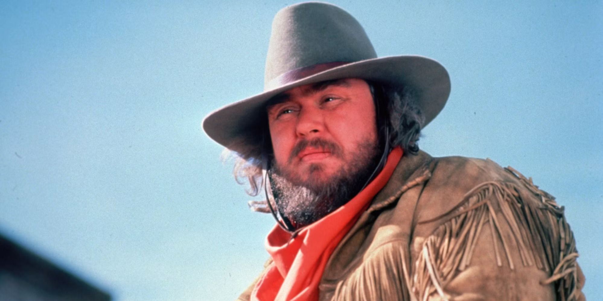 A still featuring John Candy as James Harlow in the film Wagons East!