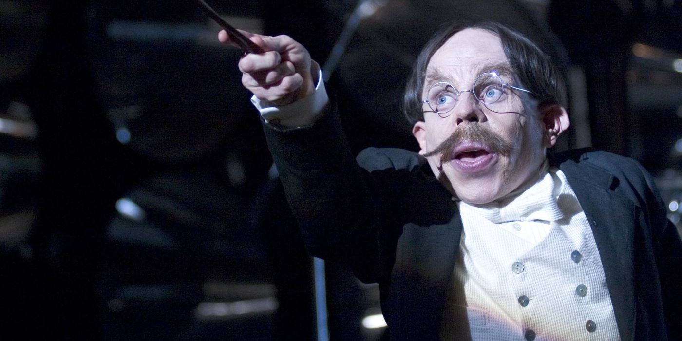 Filius Flitwick, portratyed by Warwick Davis, aiming his wand up in Harry Potter.