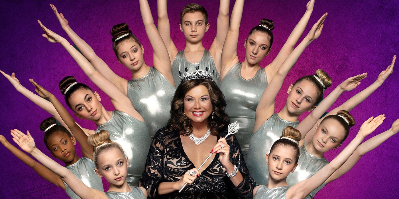Abby Lee Miller poses center with Dance Moms students surrounding her