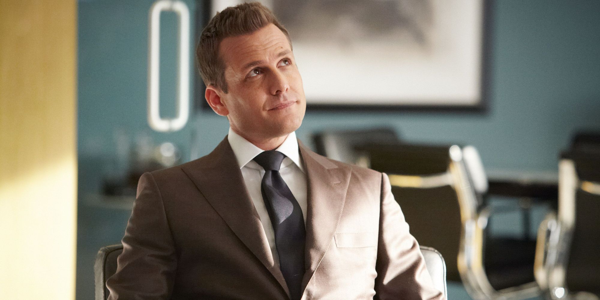 Harvey Specter, played by Gabriel Macht, looking up and smiling in Suits