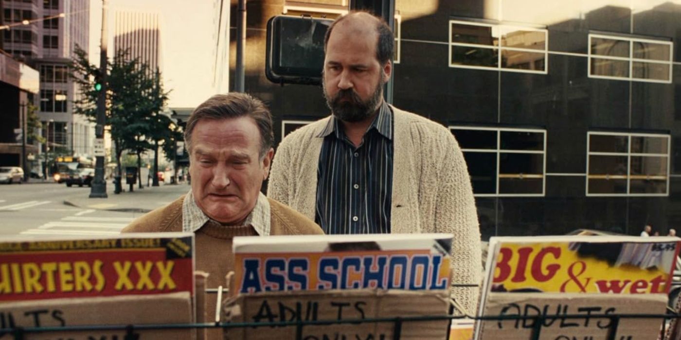 Robin Williams as Lance Clayton, looking at a rack of adult magazines and crying as Krist Novoselic comforts him in World's Greatest Dad