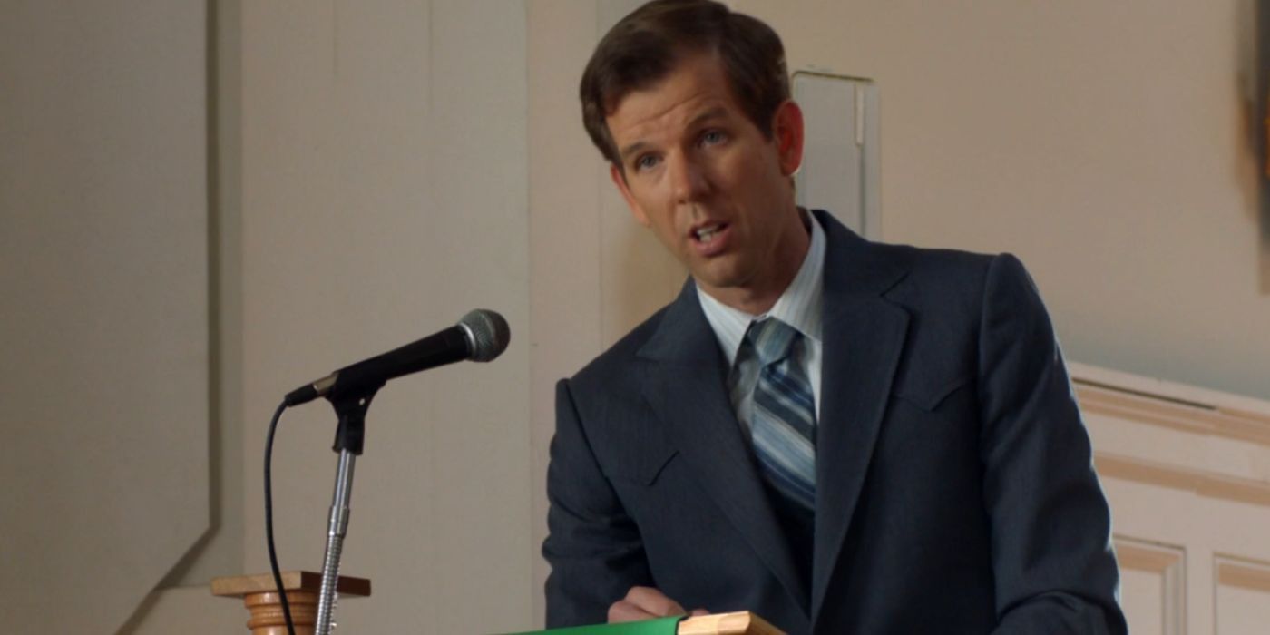 Pastor Jeff on Young Sheldon standing behind a microphone during sermon.