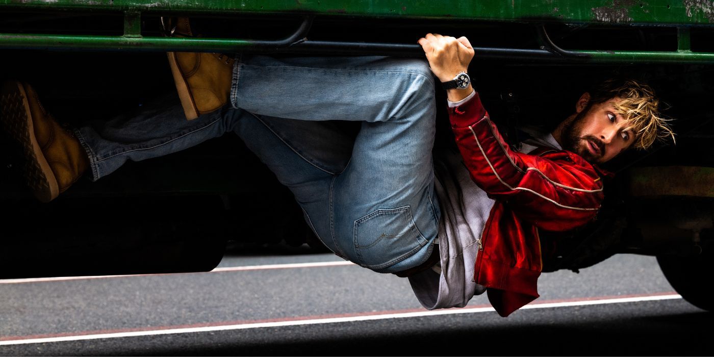 Ryan Gosling as Colt Seavers, clinging underneath a car in The Fall Guy.
