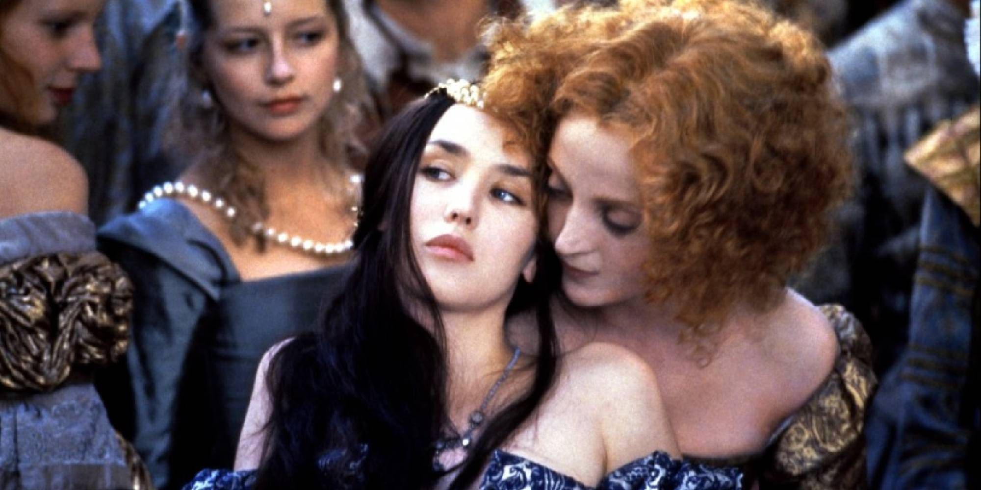 A redheaded woman leaning on Isabelle Adjani&rsquo;s shoulder in Queen Margot.