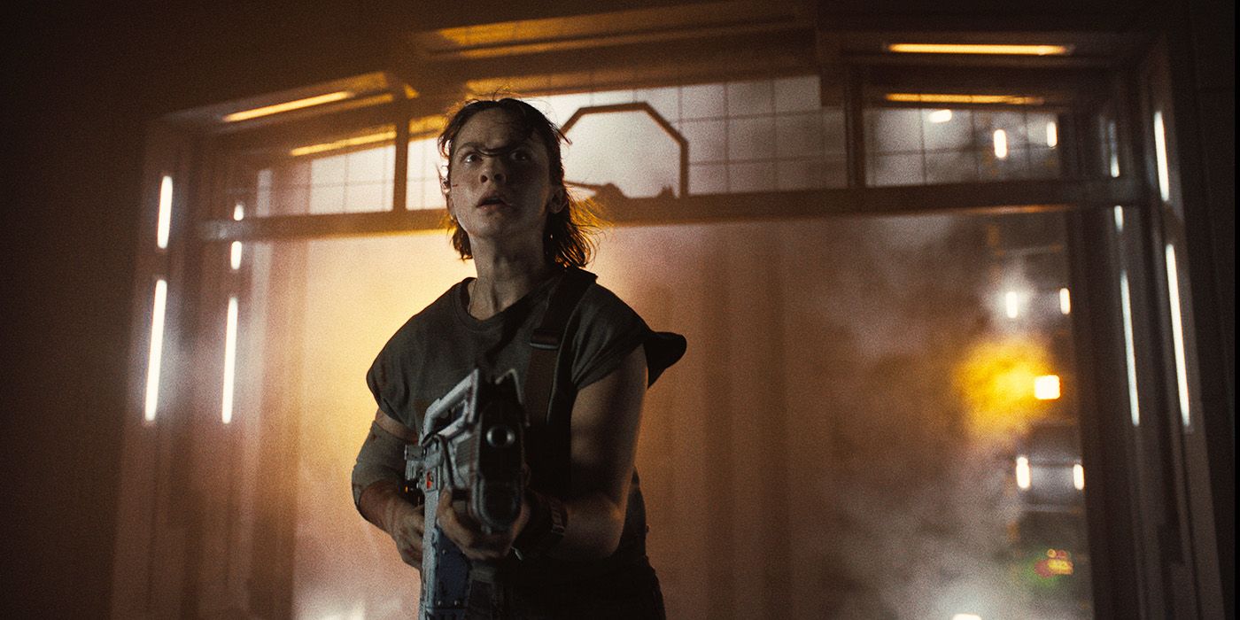 A woman holding a gun in a service elevator in Alien: Romulus