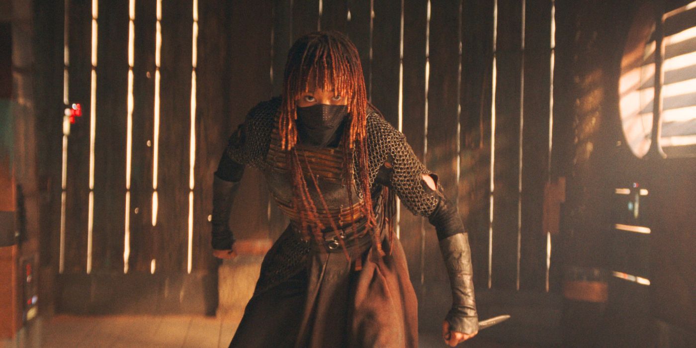 Amandla Stenberg wearing a mask and wielding a knife in The Acolyte.
