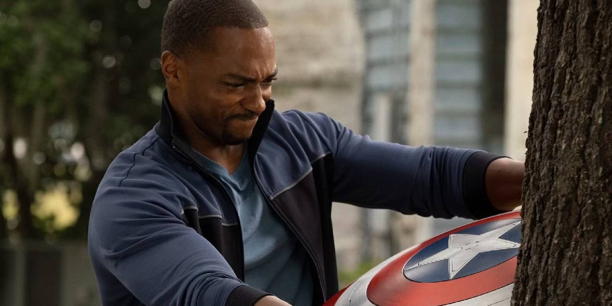 Anthony Mackie as Sam Wilson trying to take the Captain America shield off a tree in The Falcon and the Winter Soldier.