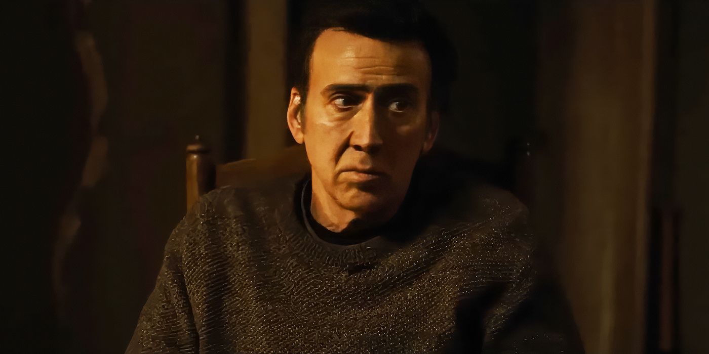 Nicolas Cage sits in a chair in Arcadian. 