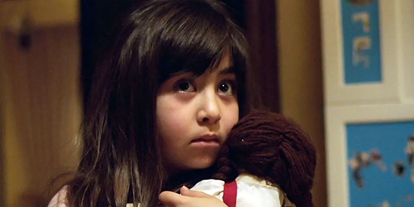 Dorsa, played by Avin Manshadi, holds her doll, Kimia, in Under the Shadow