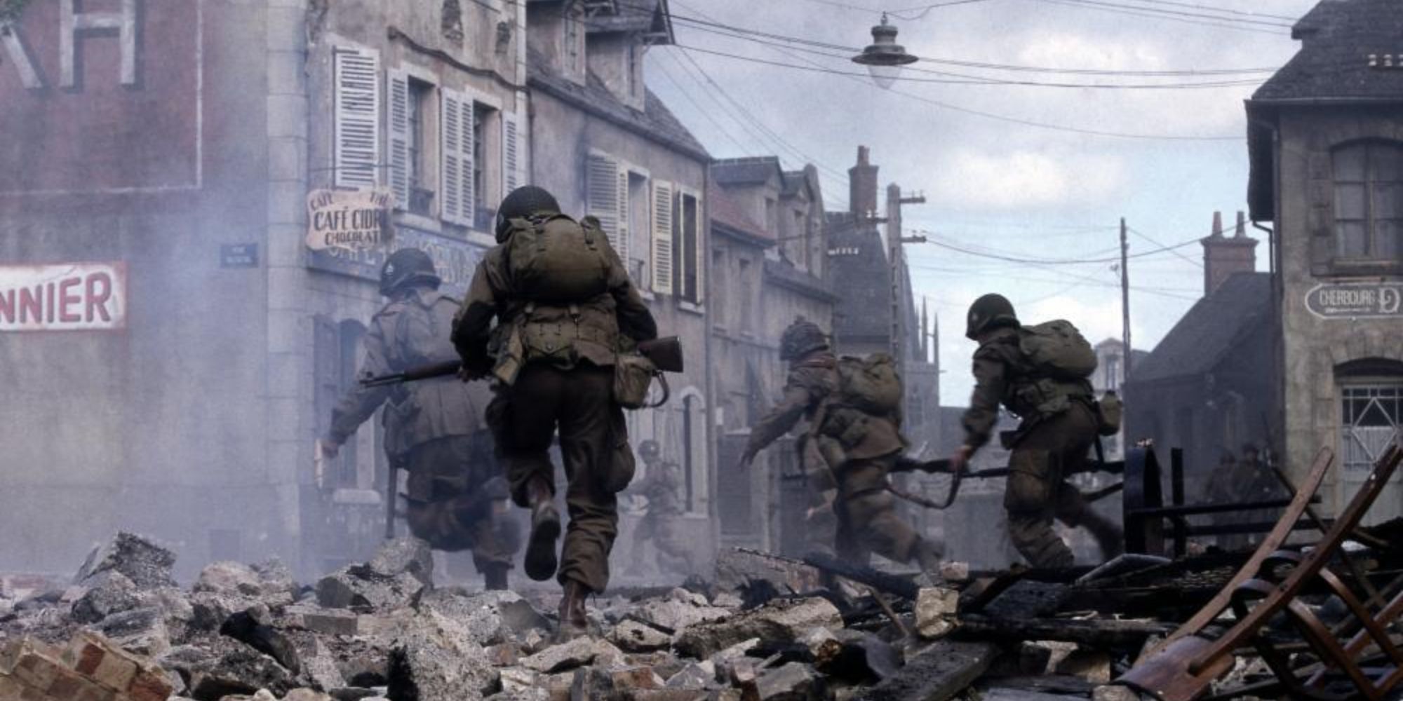 A group of soldiers running through a demolished city in Band of Brothers