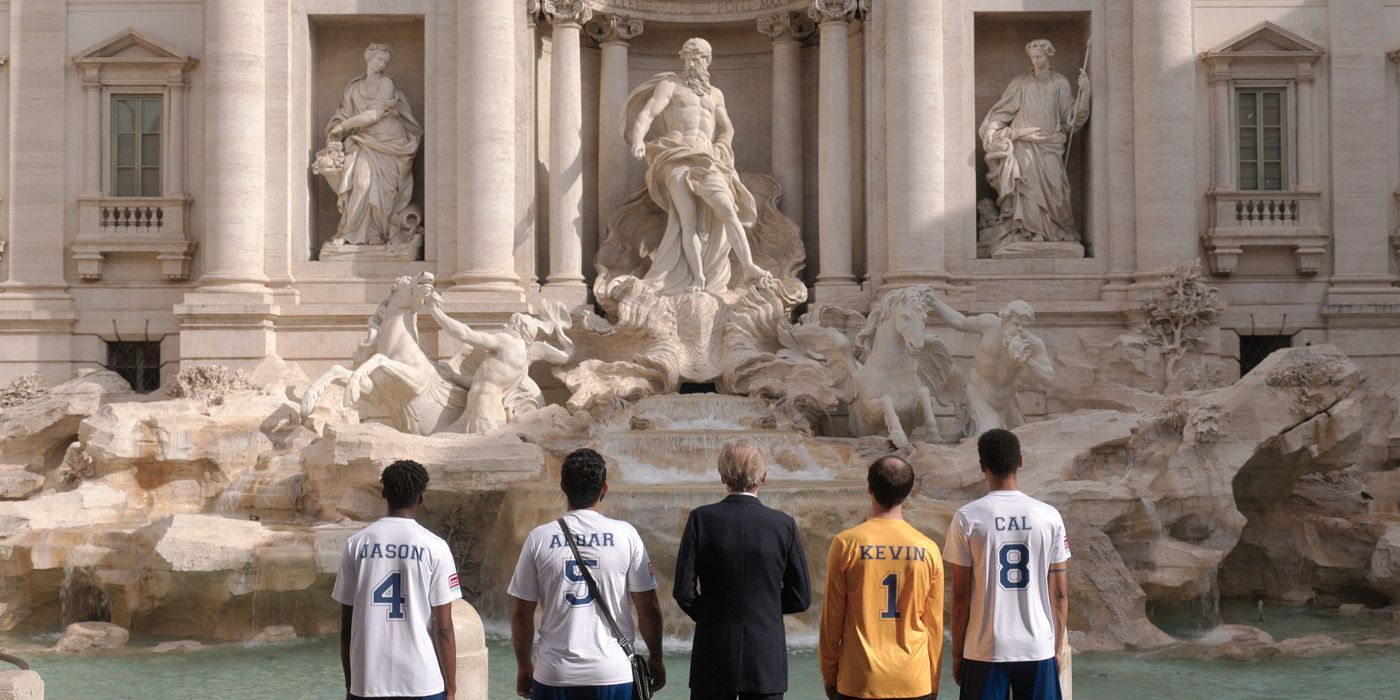 Bill Nighy and Michael Ward looking at a fountain in The Beautiful Game.